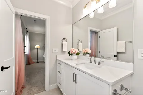 a bathroom with a tub sink and mirror