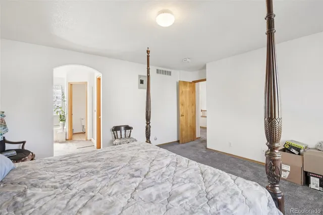 a bathroom with a tub a sink and a large mirror