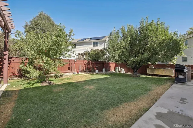 a backyard with wooden fence and a bench