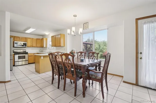 a view of a dining room with furniture and chandelier