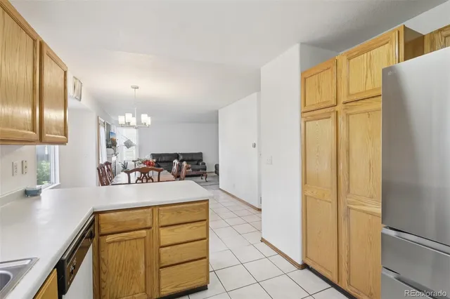 a kitchen with a refrigerator and cabinets