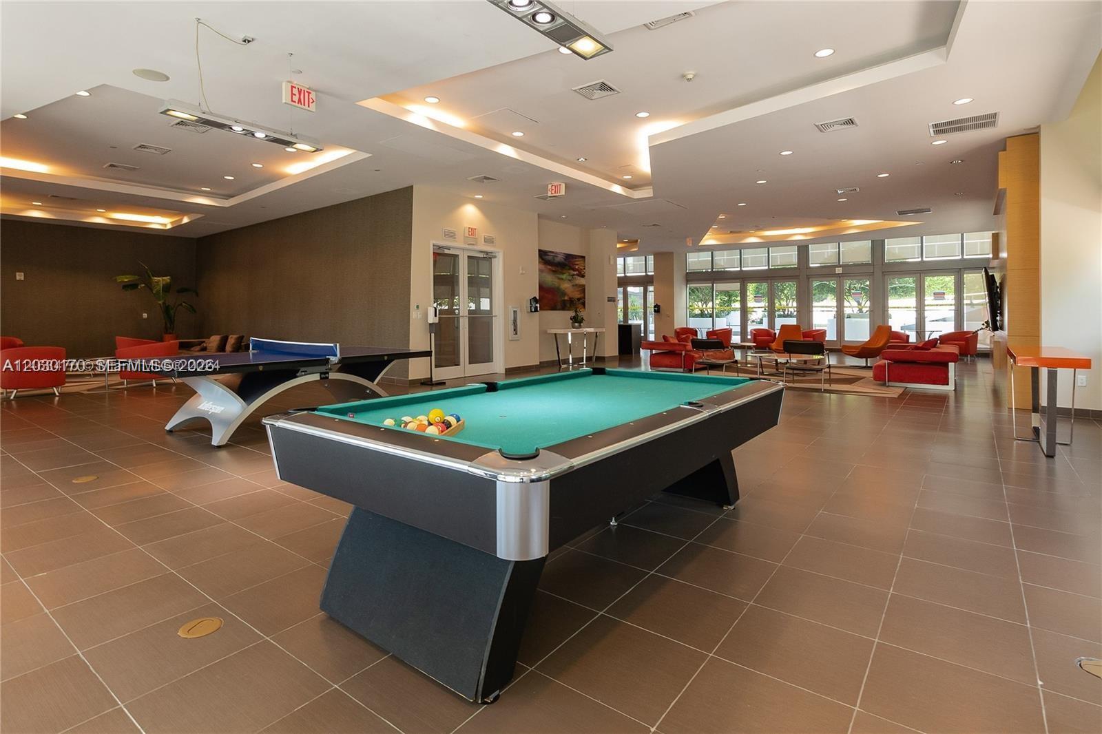 79 Southwest 12th Street, Unit 1710S Miami, FL 33130 - Photo 16 of 25 a room with gym equipment and lots of tables