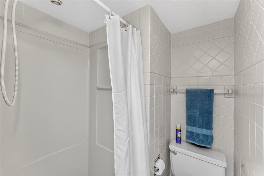 2955 North Beach Road, Unit B614 Englewood, FL 34223 - Photo 33 of 67 a bathroom with a shower and a double vanity sink