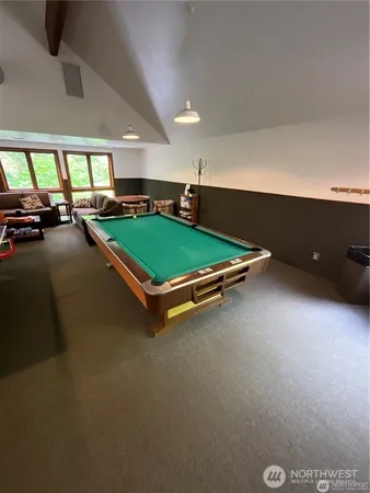 a room with pool tables and windows