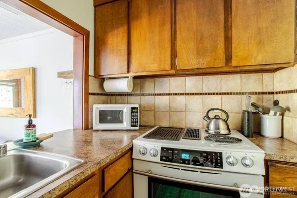 a kitchen with a stove and a sink