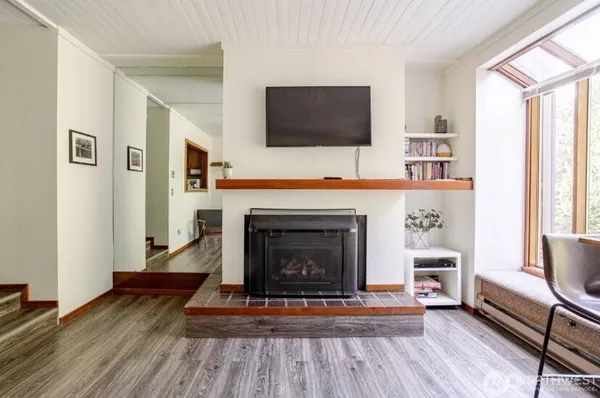 a living room with a fireplace and a flat screen tv