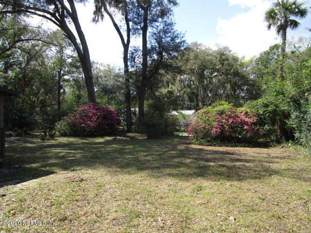 97476 Chester River Road Yulee, FL 32097 - Photo 11 of 12 a front view of a house with a yard and trees