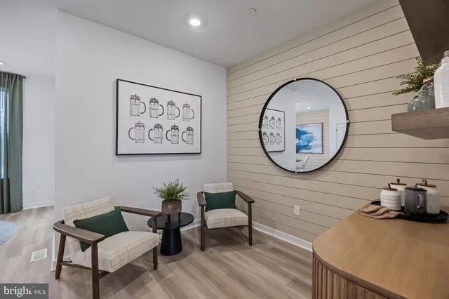 a living room with furniture and a large mirror