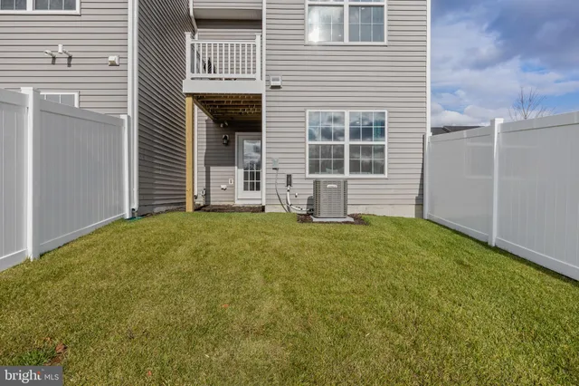 a view of a swimming pool with an outdoor seating and a yard