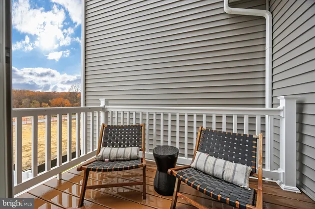a view of a roof deck with wooden floor and fence