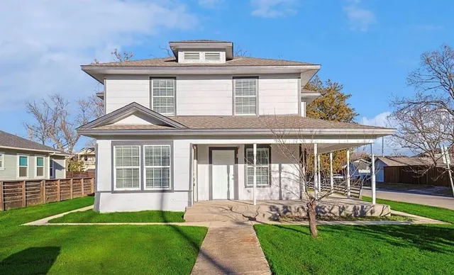a front view of a house with a yard
