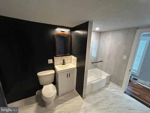 a white toilet sitting next to a bathroom sink