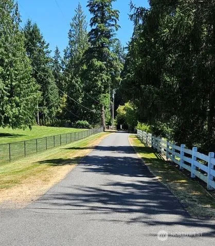 a view of a backyard with swimming pool