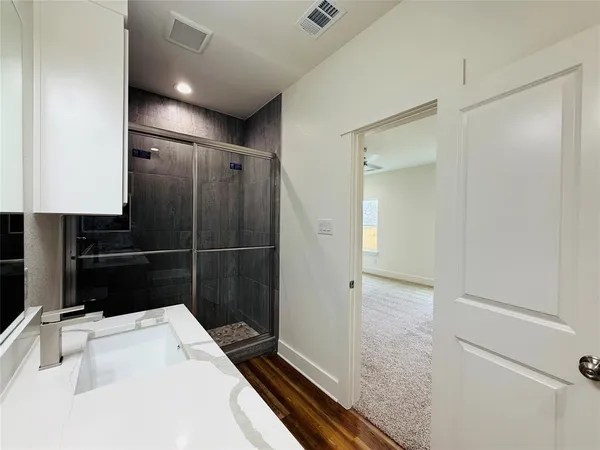 a bathroom with a sink a toilet a shower and a tub