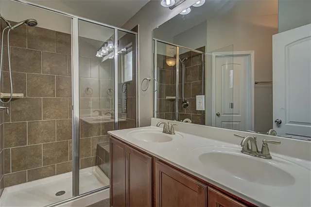 a bathroom with a shower sink and mirror