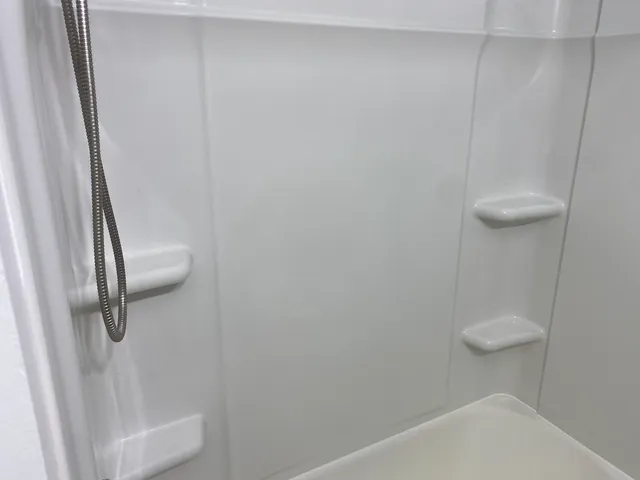 a view of a bathroom with a tub and shower