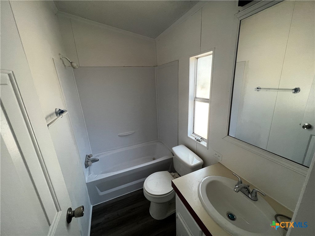 1405 Harris Hill Road, Unit 1405 San Marcos, TX 78666 - Photo 11 of 14 a bathroom with a sink toilet and shower