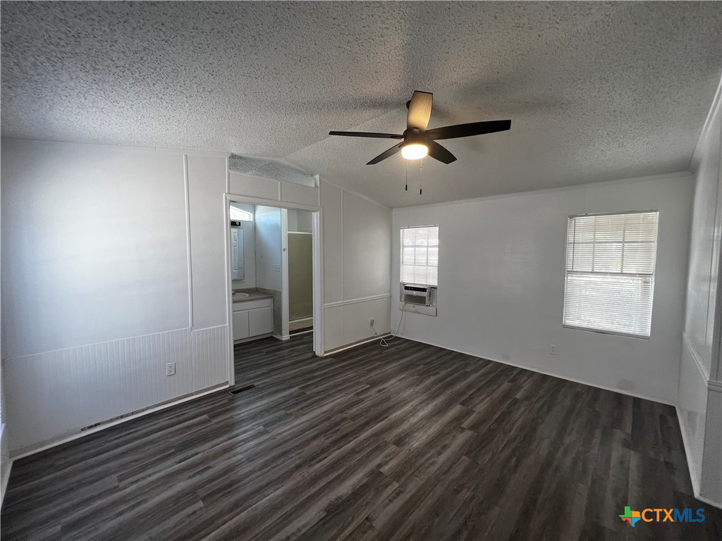 1405 Harris Hill Road, Unit 1405 San Marcos, TX 78666 - Photo 6 of 14 wooden floor in an empty room with a window
