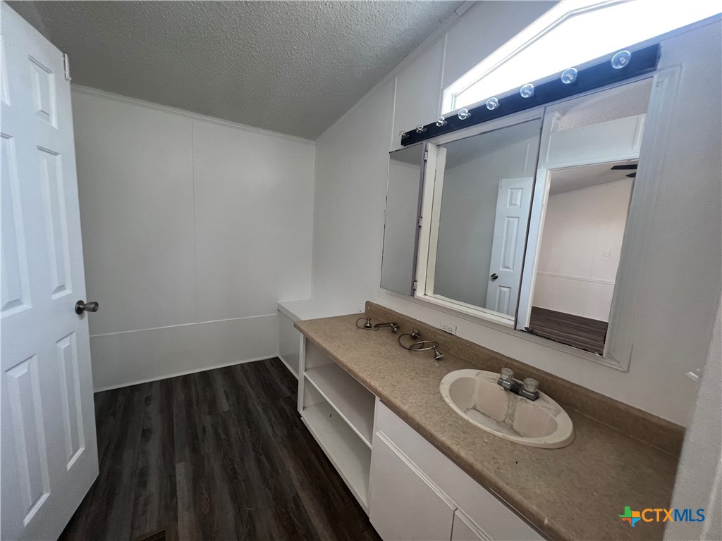 1405 Harris Hill Road, Unit 1405 San Marcos, TX 78666 - Photo 8 of 14 a bathroom with a sink and a mirror