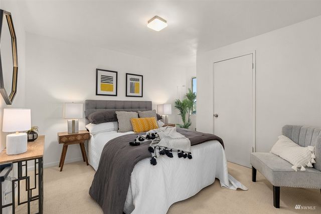 a bedroom with bed and a window