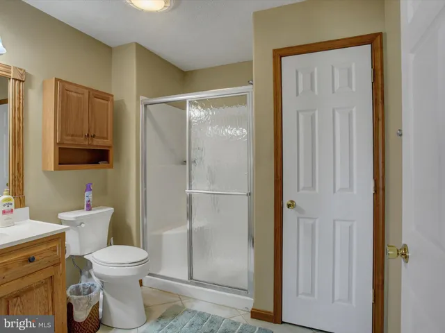 a white toilet sitting next to a bathroom sink