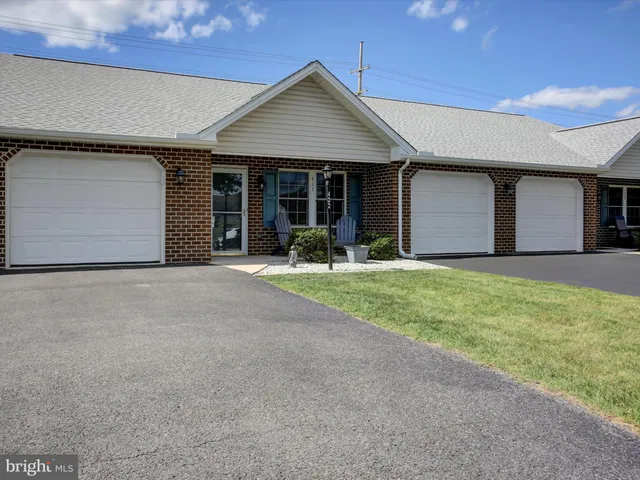 a front view of a house with yard and garage