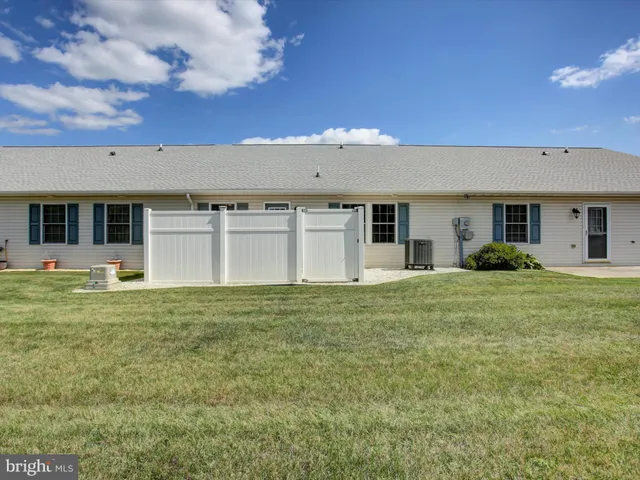 a front view of house with a garden
