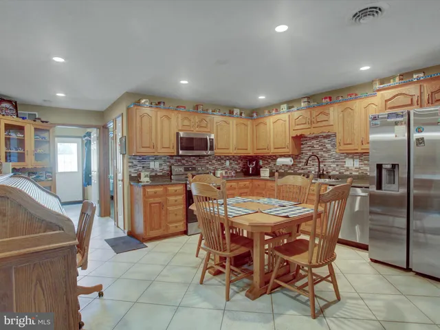 a kitchen with kitchen island granite countertop wooden floors and stainless steel appliances