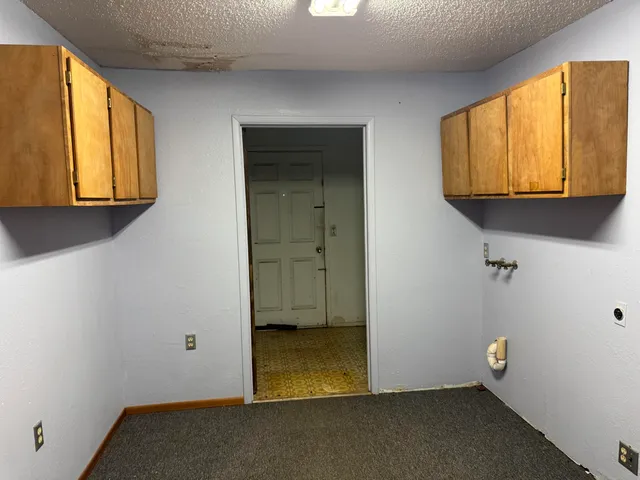 a view of room with wooden floor and cabinet