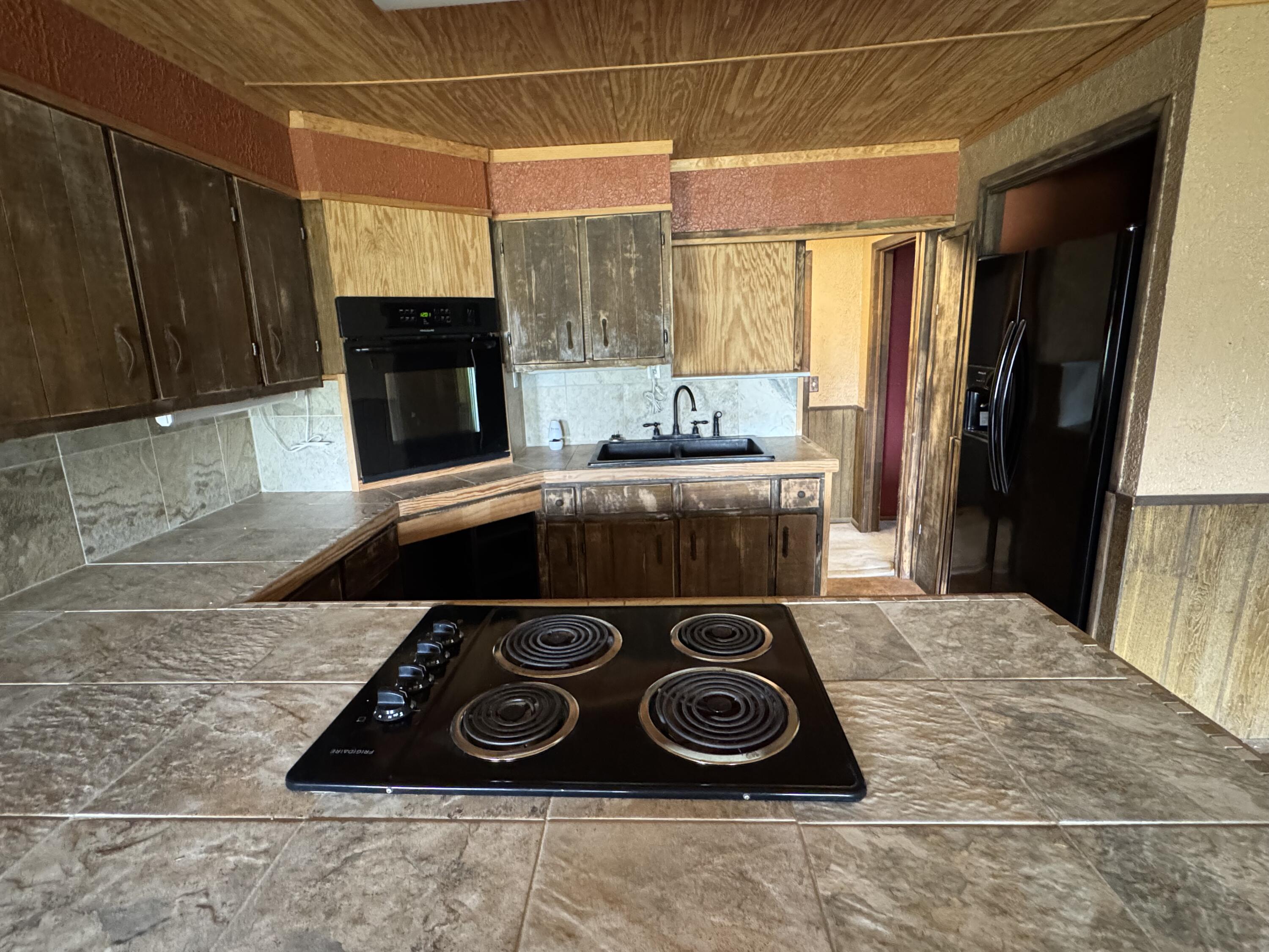 108 Southeast 10th Plainview, TX 79072 - Photo 3 of 21 a kitchen with a stove and a refrigerator