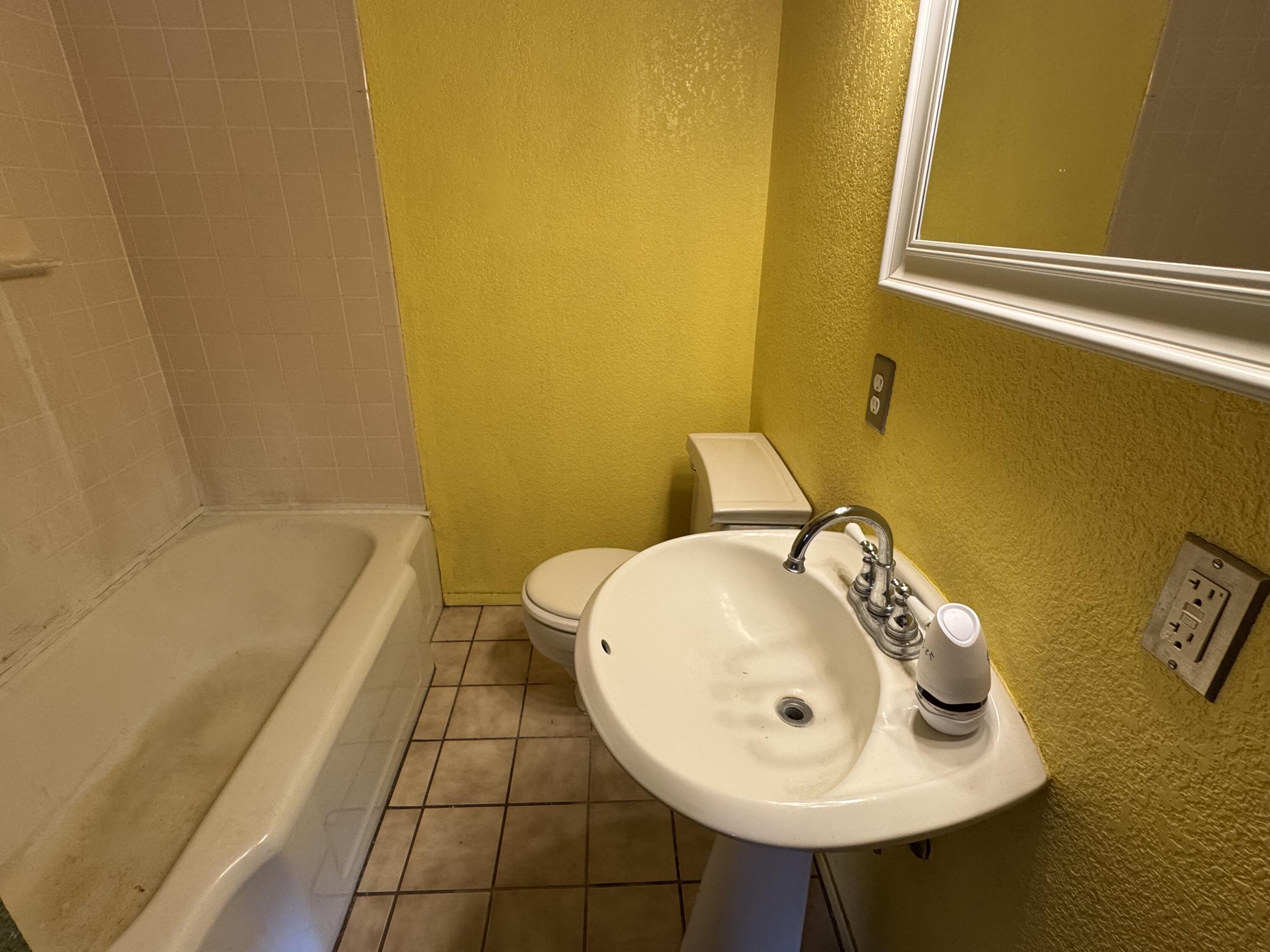 108 Southeast 10th Plainview, TX 79072 - Photo 8 of 21 a bathroom with a sink and a mirror