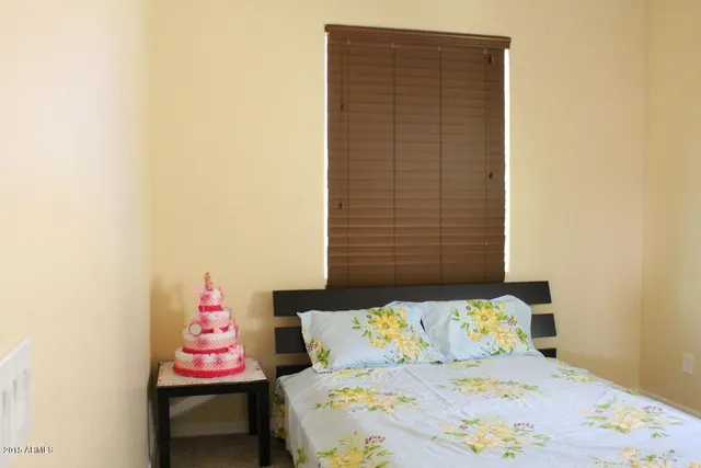 a bedroom with a bed and a table