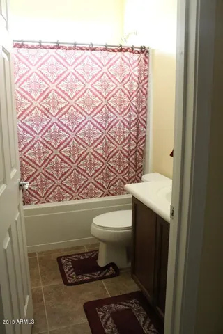 a bathroom with a toilet and a shower curtain