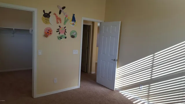 a view of a hallway with painting on the wall