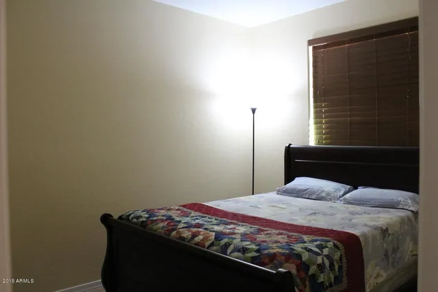 a bedroom with a bed and a window