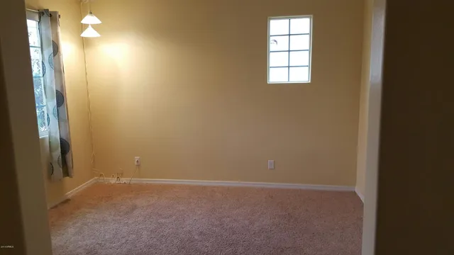 an empty room with windows and entrance