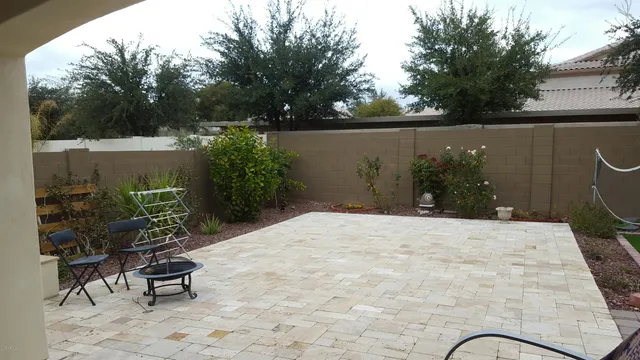 a terrace with a bench and trees