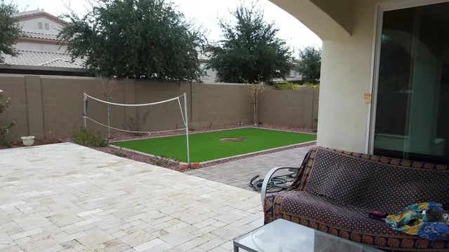 a backyard of a house with table and chairs