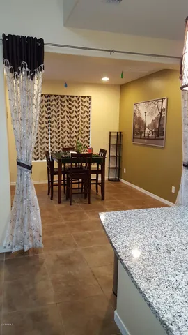 a view of kitchen island with granite countertop living room and bathroom