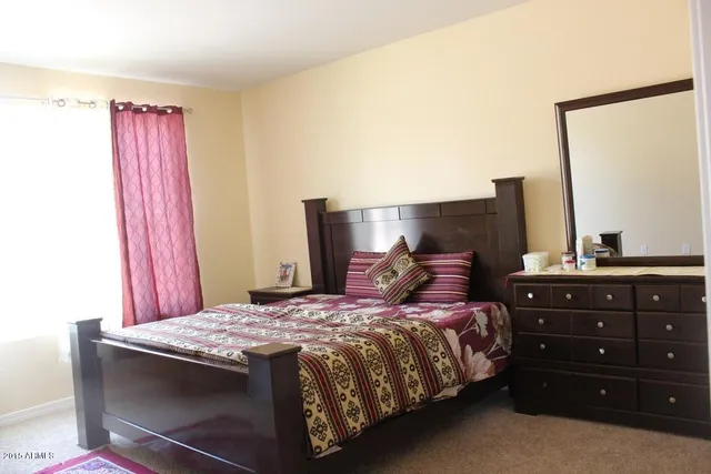 a bedroom with a bed and a dresser