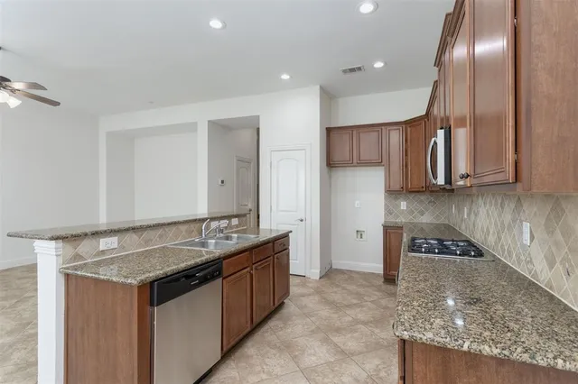 a kitchen with a sink refrigerator and cabinets