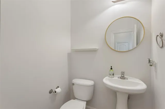 a bathroom with a sink a mirror and a toilet