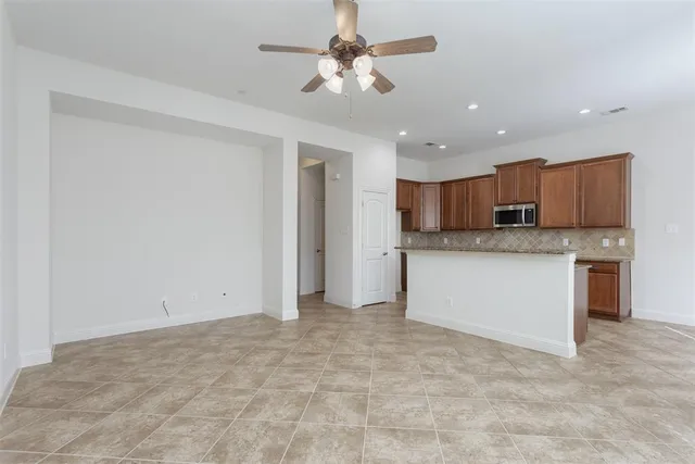 a view of a kitchen with a sink and a chandelier fan