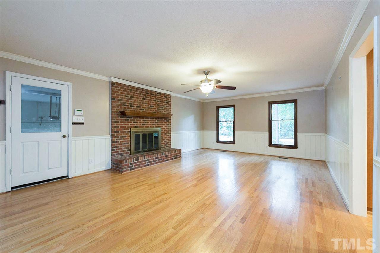 5208 Hallmark Road Durham, NC 27712 - Photo 2 of 25 a view of an empty room with wooden floor and a window