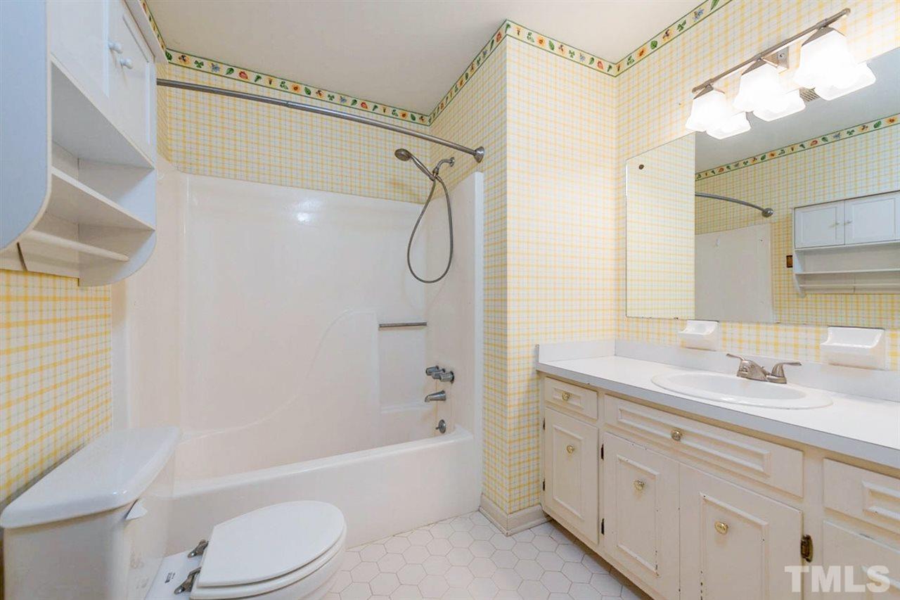 5208 Hallmark Road Durham, NC 27712 - Photo 21 of 25 a bathroom with a granite countertop bathtub shower sink vanity mirror and toilet