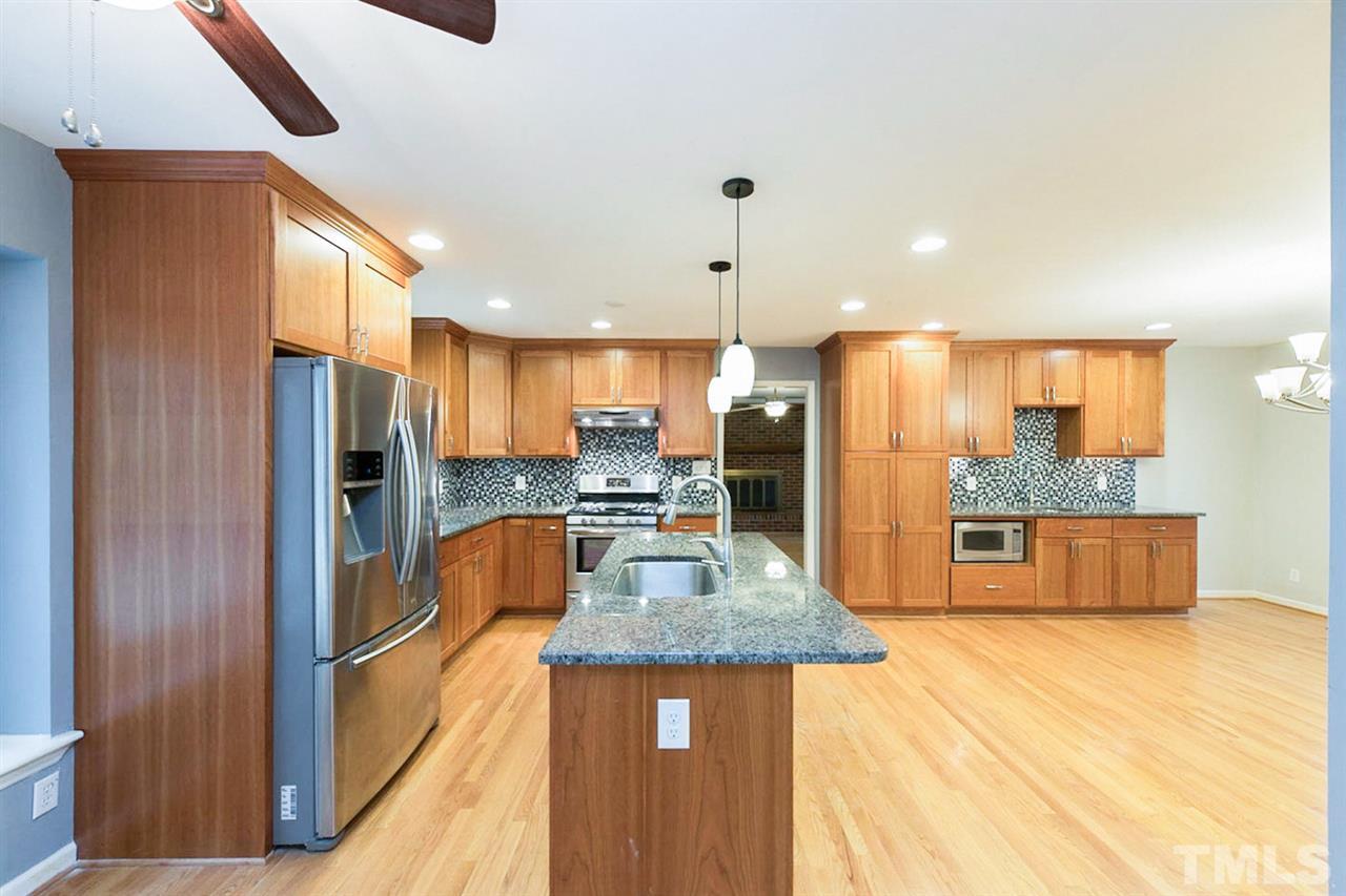 5208 Hallmark Road Durham, NC 27712 - Photo 9 of 25 a kitchen with stainless steel appliances granite countertop a refrigerator a oven a sink with island and chairs