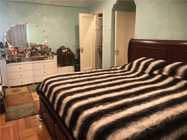 a bedroom with a bed and lamp