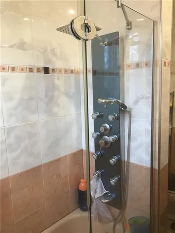 a bathroom with a glass shower door