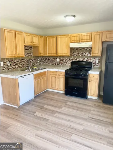 a kitchen with stainless steel appliances granite countertop a stove and a refrigerator