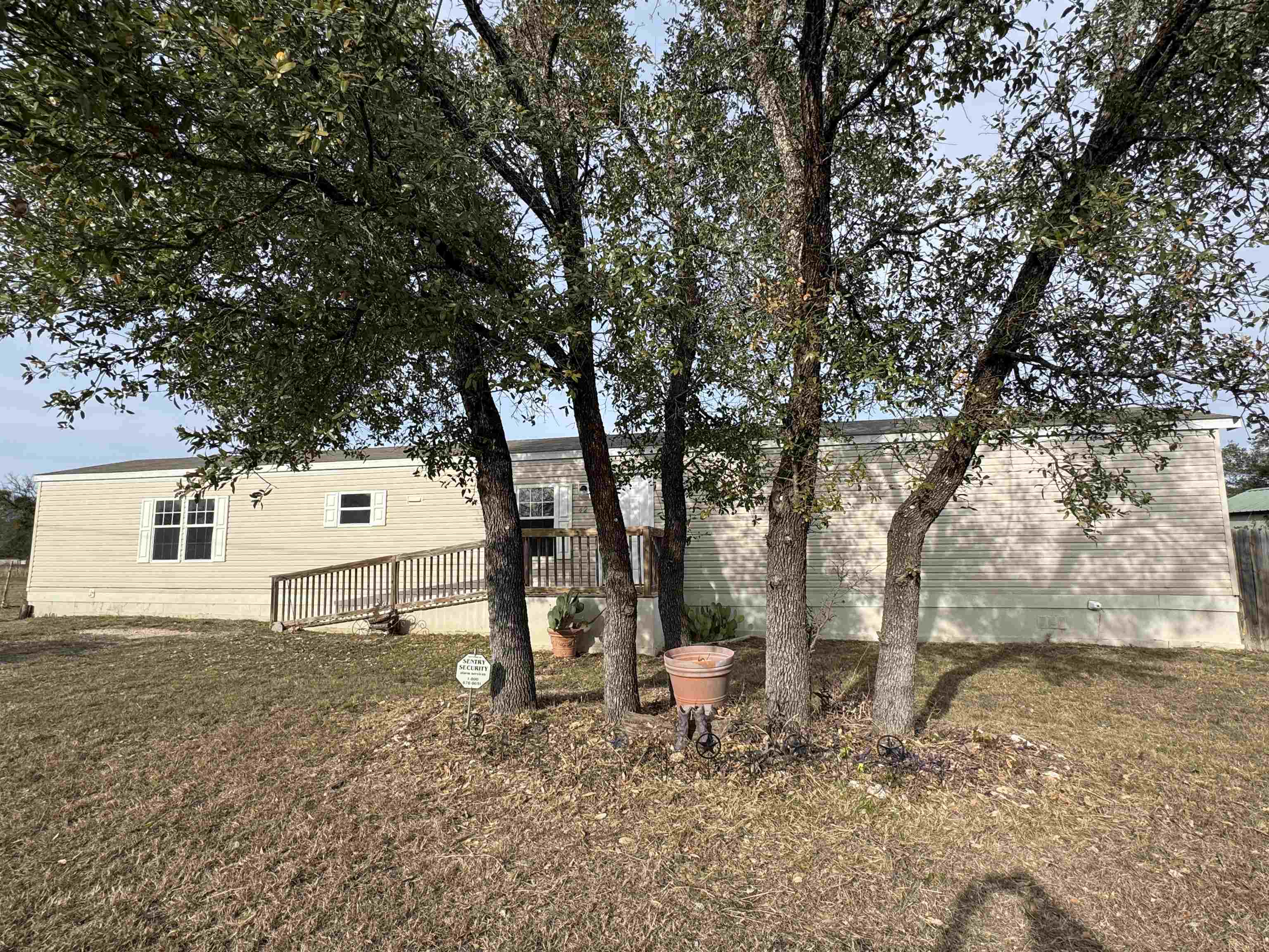 a backyard of a house with table and chairs